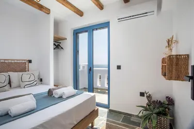 a bedroom with a bed and a large window at Villa Mare Mio, beachfront, newly rennovated in Lachania