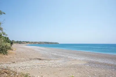 a rocky beach with the ocean in the background at Villa Mare Mio, beachfront, newly rennovated in Lachania