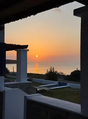 a sunset over the ocean from a villa at Villa Mare Mio, beachfront, newly rennovated in Lachania