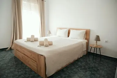 a bedroom with a large bed with two pillows on it at ANASTASIAS HOUSE a in Rhodes Town