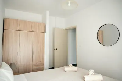 a bedroom with a bed with a mirror and a closet at ANASTASIAS HOUSE a in Rhodes Town