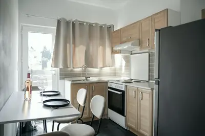 a small kitchen with a table and a refrigerator at ANASTASIAS HOUSE a in Rhodes Town