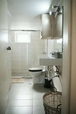 a white bathroom with a toilet and a sink at ANASTASIAS HOUSE a in Rhodes Town