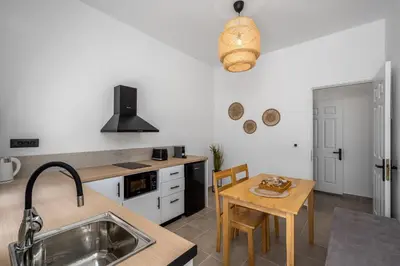 a kitchen with a table and a dining room at Elpidas Apartments in Symi