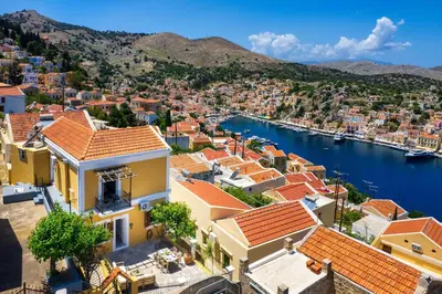 an aerial view of a town with a harbor at Elpidas Apartments in Symi