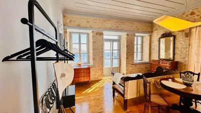 a living room with a table and a dining room at H-aris Seafront Mansion in Halki