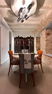 a dining room with a table and chairs at H-aris Seafront Mansion in Halki