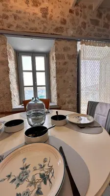 a table with a glass bowl on top of it at H-aris Seafront Mansion in Halki