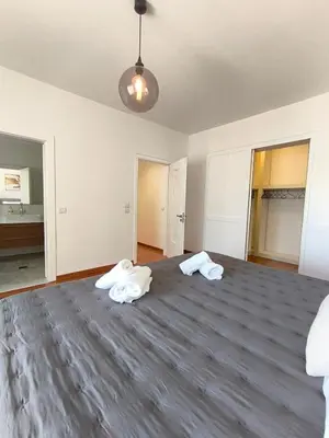 an empty room with two white towels on a bed at Downtown Luxury Apartment in Rhodes Town