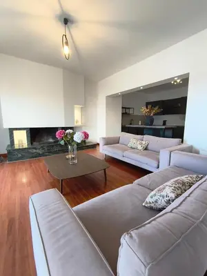 a living room with two couches and a fireplace at Downtown Luxury Apartment in Rhodes Town