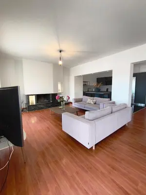 a living room with two white couches and a television at Downtown Luxury Apartment in Rhodes Town