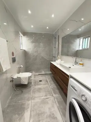 a bathroom with a sink and a washing machine at Downtown Luxury Apartment in Rhodes Town