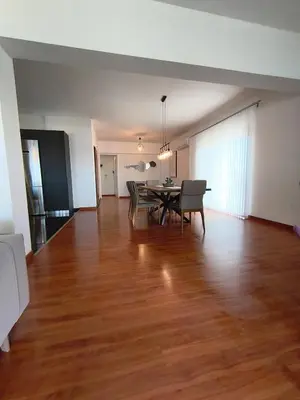 an empty living room with a table and chairs at Downtown Luxury Apartment in Rhodes Town