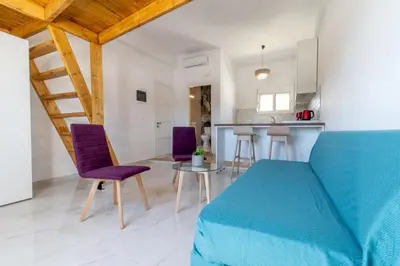 a bedroom with a bed and a table and chairs at Caserma Regina in Rhodes Town
