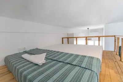 a large bed with a white pillow on top of it at Caserma Regina in Rhodes Town