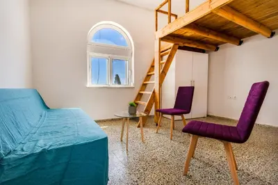 a room with two purple chairs and a ladder at Caserma Regina in Rhodes Town