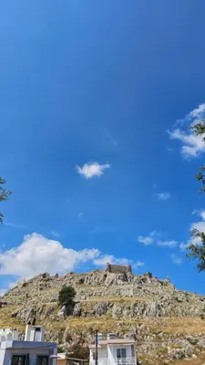 a view of a mountain with a blue sky at Haraki De Sol Beach Apartments in Haraki
