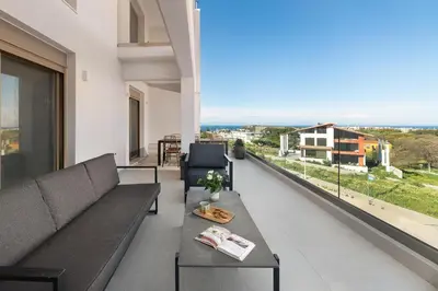 a living room with a couch and a table at Evilion Island Residence in Ixia
