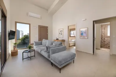 a living room with a couch and a chair at Evilion Island Residence in Ixia