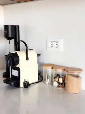 a kitchen counter with a coffee maker and other items at Evilion Island Residence in Ixia