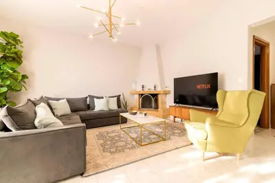 a living room with a couch and a tv at Central House of Ialisos in Ialyssos