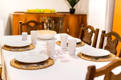 a table with white plates and napkins on it at Central House of Ialisos in Ialyssos