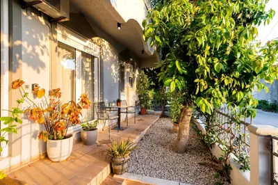 a balcony with potted plants on a building at Central House of Ialisos in Ialyssos