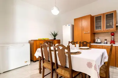 a kitchen with a table and chairs and a refrigerator at Central House of Ialisos in Ialyssos