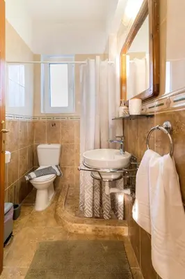 a bathroom with a sink and a toilet at Central House of Ialisos in Ialyssos