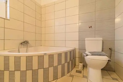 a bathroom with a bath tub and a toilet at Central House of Ialisos in Ialyssos