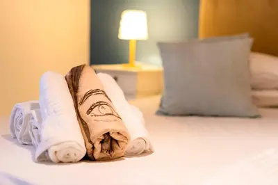 a pile of towels sitting on top of a bed at Central House of Ialisos in Ialyssos