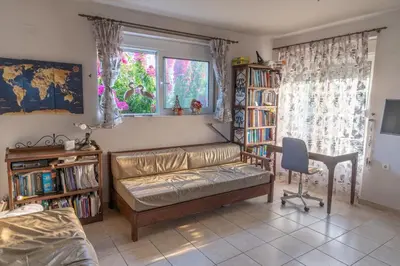 a room with a couch and a desk and a window at Private House, Peaceful Stylish Retreat Near Ialisos Beach, up to 5 Guests in Ialyssos