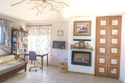 a living room with a couch and a fireplace at Private House, Peaceful Stylish Retreat Near Ialisos Beach, up to 5 Guests in Ialyssos