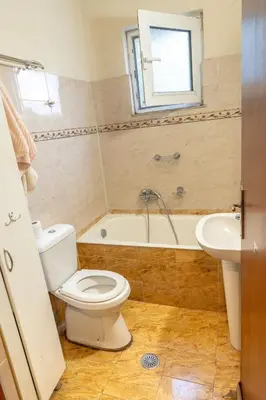 a bathroom with a toilet and a tub and a sink at Private House, Peaceful Stylish Retreat Near Ialisos Beach, up to 5 Guests in Ialyssos