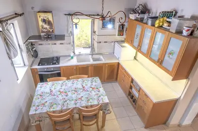 an overhead view of a kitchen with a table and chairs at Private House, Peaceful Stylish Retreat Near Ialisos Beach, up to 5 Guests in Ialyssos