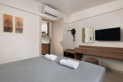 a bedroom with a bed with two white towels at Ama Apartments in Rhodes Town