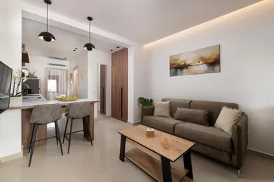 a living room with a couch and a table at Ama Apartments in Rhodes Town