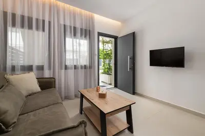 a living room with a couch and a table at Ama Apartments in Rhodes Town
