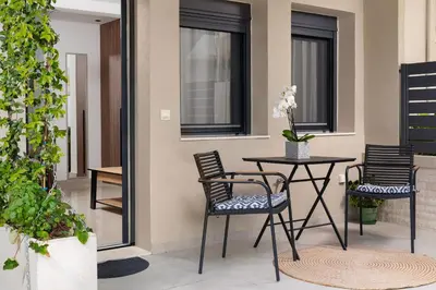 a patio with chairs and a table with a table at Ama Apartments in Rhodes Town