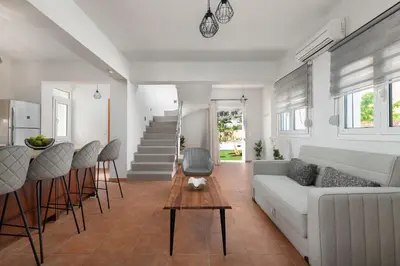 a living room with a couch and a table at Avia Villa in Pefki Rhodes