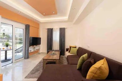 a living room with a couch and a tv at Modern Colorful House 1 rhodos in Rhodes Town