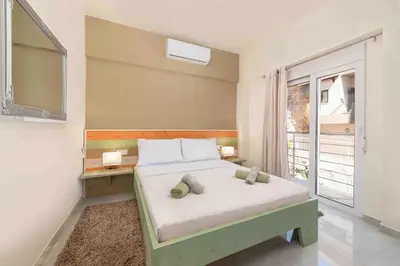 a bedroom with a bed and a large window at Modern Colorful House 1 rhodos in Rhodes Town