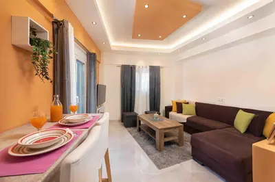a living room with a couch and a table at Modern Colorful House 1 rhodos in Rhodes Town