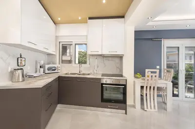 a kitchen with a sink and a stove top oven at Modern Colorful House 3 in Rhodes Town