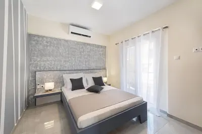 a bedroom with a large bed and a window at Modern Colorful House 3 in Rhodes Town