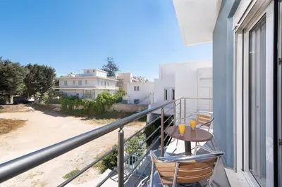 a balcony with a table and chairs on a building at Modern Colorful House 3 in Rhodes Town