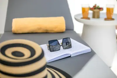a pair of glasses sitting on a table with a book at Chrispa Villa in Afantou