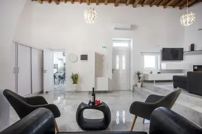 a living room with black chairs and a couch at Chrispa Villa in Afantou