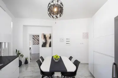 a dining room with a table and chairs and a chandelier at Chrispa Villa in Afantou