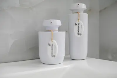 two white vases sitting on a white shelf at Chrispa Villa in Afantou